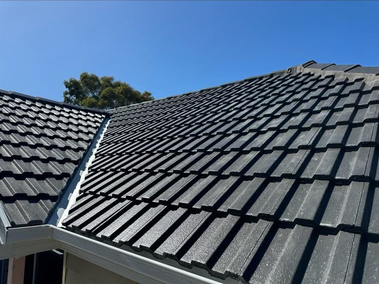 Charcoal flat tiles finished to the gutter line