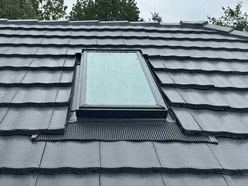 Tile roof re-laid around an existing skylight